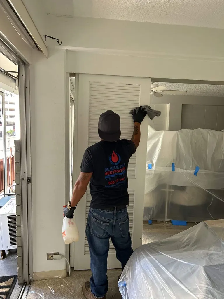 A doorway sealed with plastic containment sheeting during water damage restoration